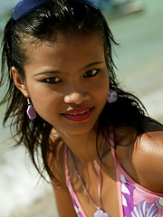 Asian teen model at the beach poses on a Jet Ski